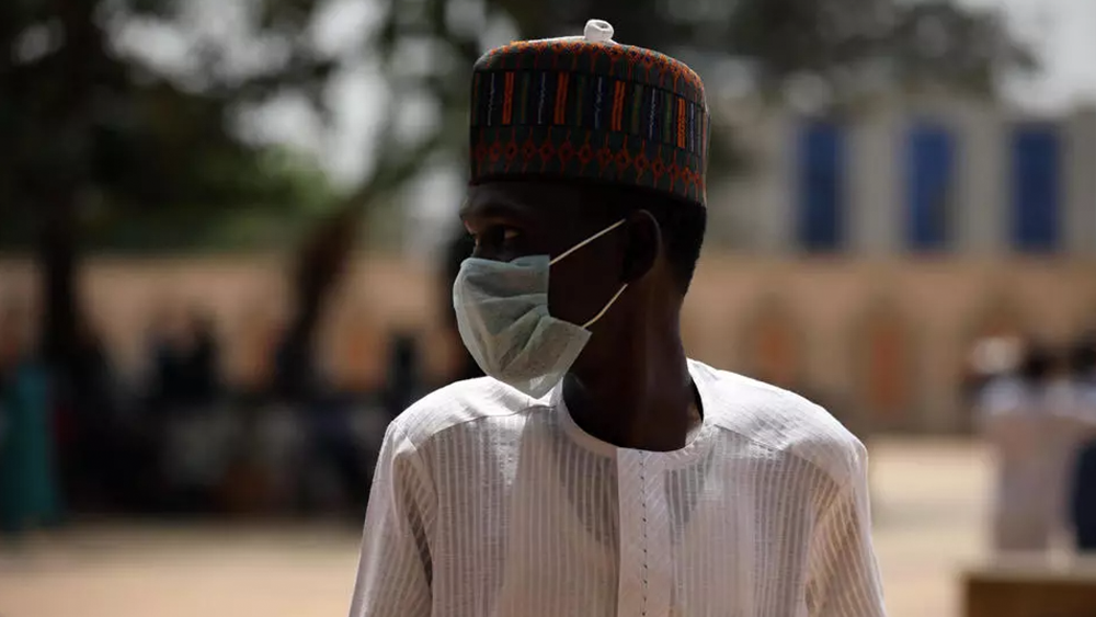 A man wears a face mask amid concerns of the spreading of the coronavirus during Friday prayers in Abuja, Nigeria on 20 March 2020. Kola Sulaimon/AFP 
