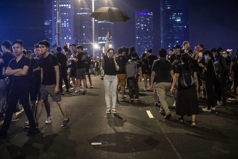 A protester holds up an umbrella on Harcourt Road during a rally in Hong Kong on Sunday.
Photo Credit: Justin Chin/Bloomberg