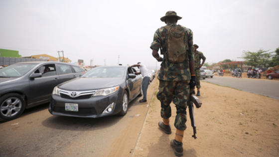 A soldier observes temperature checks at the border between Abuja and Nasarawa states in Nigeria, as the authorities try to limit the spread of the coronavirus disease (COVID-19), on March 30, 2020. Afolabi Sotunde/Reuters